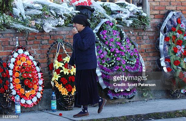 Woman walks by a memorial to the terror victims at School No. 1 September 8, 2004 in Beslan, southern Russia. Approximately 355 children and adults...