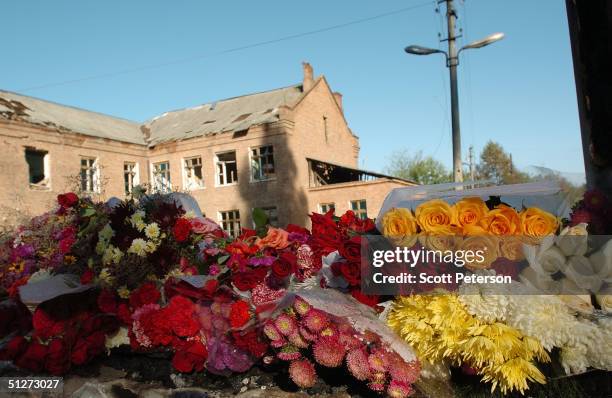 Flowers sit at School No. 1 to form a memorial to the terror victims September 8, 2004 in Beslan, southern Russia. Approximately 355 children and...