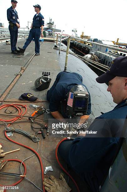 Ht2 Daniel Hunter and HT2 Rocky Weidow work on upgrades aboard the Trident Submarine USS Georgia at the Naval Base Point Loma September 8, 2004in San...