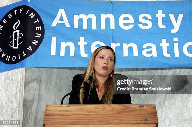 Actress Mira Sorvino, an ambassador activist for Amnesty International's stop violence against women campaign, speaks during an exhibit of Sudanese...
