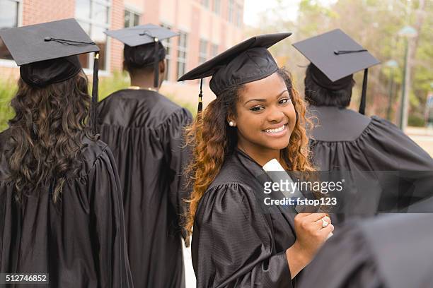education: african descent female graduate and friends on college campus. - african ethnicity stock pictures, royalty-free photos & images