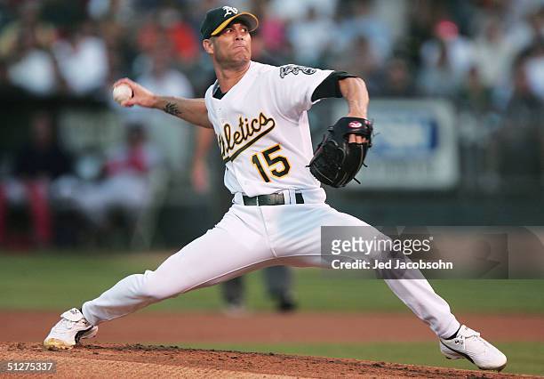 Tim Hudson of the Oakland Athletics delivers a pitch against the Boston Red Sox during a MLB game at the Network Associates Coliseum on September 7,...