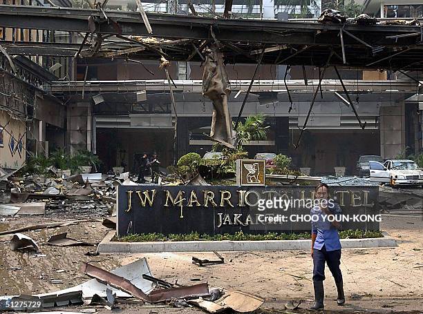 This file photo dated 05 August 2003 shows an Indonesian firefighter walking past the damaged JW Marriott Hotel in Jakarta after an explosion tore...