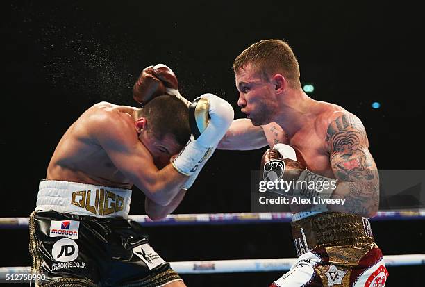 Carl Frampton and Scott Quigg in action during their World Super-Bantamweight title contest at Manchester Arena on February 27, 2016 in Manchester,...