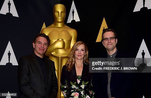 Makeup and Hairstyling artists from the film 'The Revenant' Robert Pandini , Sian Grigg and Duncan Jarman pose beside a statue of the Oscar at a...