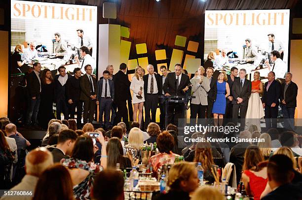 Producer Michael Sugar accepts the Best Feature award for "Spotlight" onstage with members of the film's cast and crew, as well as some of the real...