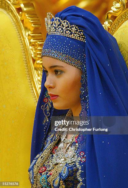 Commoner Sarah Salleh, in radiant blue, is seen during her wedding to Bruneian Crown Prince Al-Muhtadee Billah Bolkiah at the Balai Singgahsana ,...