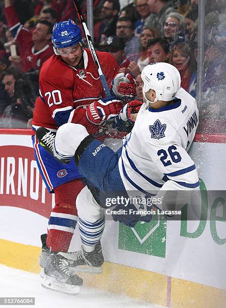 Victor Bartley of the Montreal Canadiens checks Daniel Winnik of the Toronto Maple Leafs in the NHL game at the Bell Centre on February 27, 2016 in...