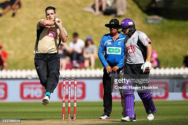 Mitchell McClenaghan of North Island bowls while Tom Latham of South Island looks on during the Island of Origin Twenty20 at Basin Reserve on...