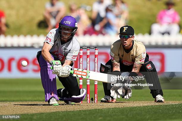 Henry Nicholls of South Island bats while Luke Ronchi of North Island looks on during the Island of Origin Twenty20 at Basin Reserve on February 28,...