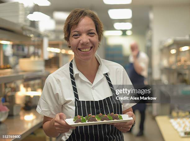 Chef Nina Compton prepares food for a Dinner Hosted By Scott Conant, Michael Pirolo And Nina Compton during 2016 Food Network & Cooking Channel South...