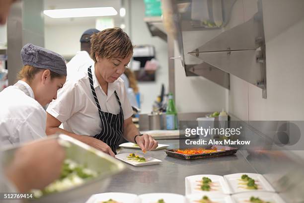 Chef Nina Compton prepares food for a Dinner Hosted By Scott Conant, Michael Pirolo And Nina Compton during 2016 Food Network & Cooking Channel South...