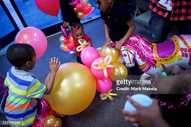 Children and families from the local community attend a birthday party for a 4 year old girl, A'nara, at the Cordova Town Hall polling precinct on...