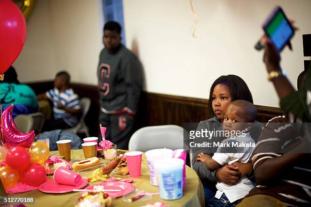 Children and families from the local community hold a birthday party for a 4 year old girl, A'nara, at the Cordova Town Hall polling precinct on the...