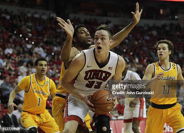 Jordon Naughton of the Wyoming Cowboys guards Stephen Zimmerman Jr. #33 of the UNLV Rebels during their game at the Thomas & Mack Center on February...