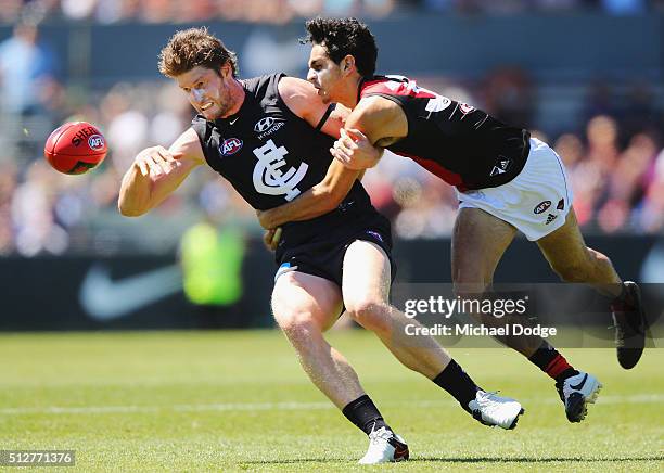 Jake Long of the Bombers tackles Sam Rowe of the Blues during the 2016 AFL NAB Challenge match between Carlton and Essendon at Ikon Park on February...