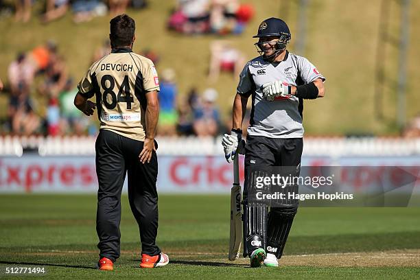 Nathan McCullum of South Island enjoys a laugh with Anton Devcich of North Island during the Island of Origin Twenty20 at Basin Reserve on February...