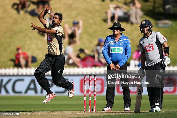Ish Sodhi of North Island bowls while Nathan McCullum of South Island looks on during the Island of Origin Twenty20 at Basin Reserve on February 28,...