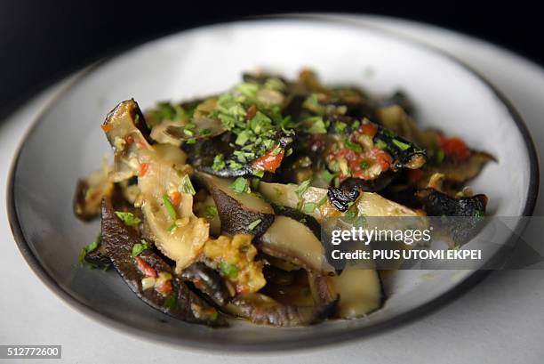 Picture taken on January 14, 2016 shows snail food prepared by Pierre Thiam at Nok By Alara, a restaurant in Victoria Island district of Lagos. An...