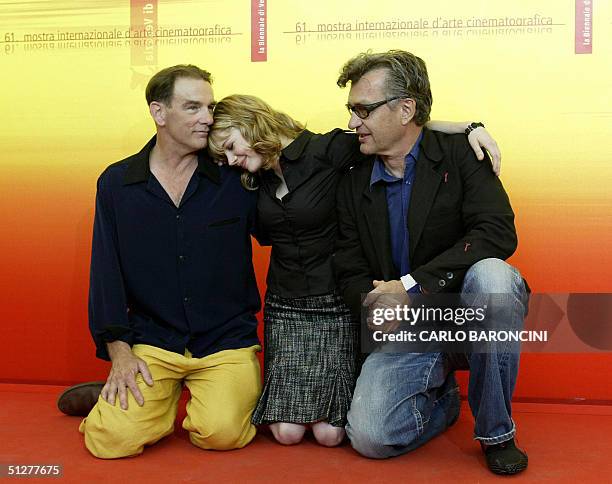 German director Wim Wenders poses with Michelle Williams and John Diehl during a photocall at Venice Lido, 9 September 2004. Wenders presents his...