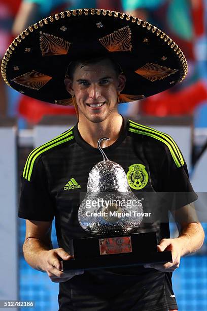 Dominic Thiem of Austria poses for pictures after winning the men's final singles match between Bernard Tomic of Australia and Dominic Thiem of...