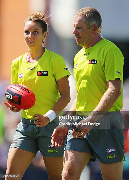 Umpire Eleni Glouftsis, becoming the first female field umpire to adjudicate an official AFL match today, leads the team off at half time during the...