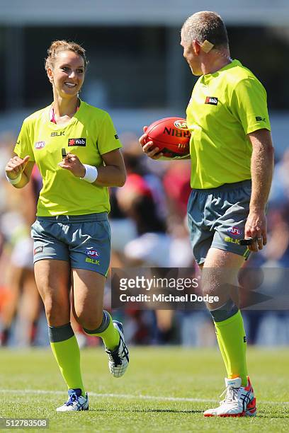 Umpire Eleni Glouftsis, becoming the first female field umpire to adjudicate an official AFL match today, leads the team off at half time during the...