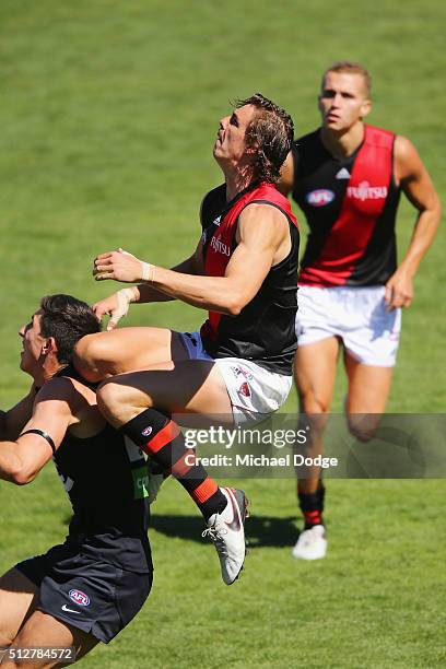 Joe Daniher of the Bombers leaps for a marking attempt over Jacob Weitering of the Blues during the 2016 AFL NAB Challenge match between Carlton and...