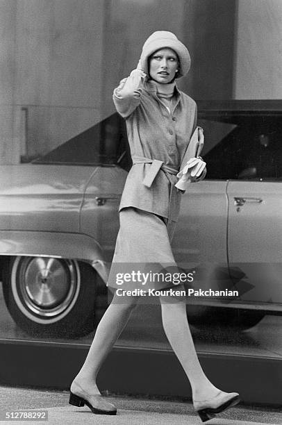 Model wearing a belted shirt-jacket and skirt of wool and rabbit's hair over a wool and angora turtleneck by Chester Weinberg.