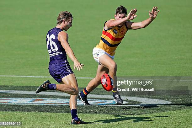 Mitch McGovern of the Crows tries to spoil a kick from Ed Langdon of the Dockers during the 2016 AFL NAB Challenge match between the Fremantle...