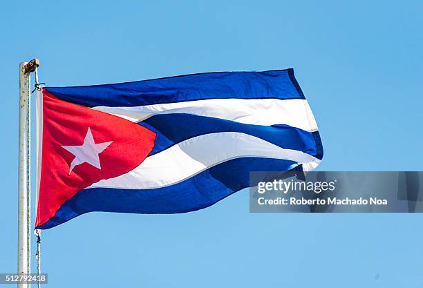 Colorful Cuban flag waiving high in the air, beautiful red, white, blue colors.