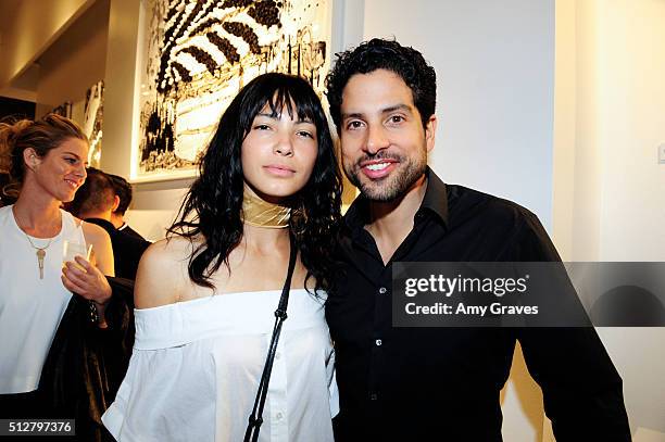 Grace Kale and Adam Rodriguez attend the "Tom Everhart "Raw" Exhibition of His Schulz-influenced Paintings For The First Time In Black And White At...