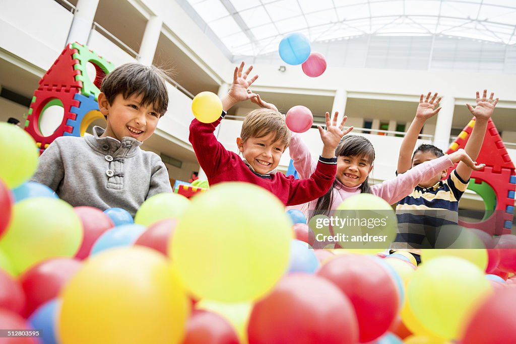 Kids playing at a ball pool