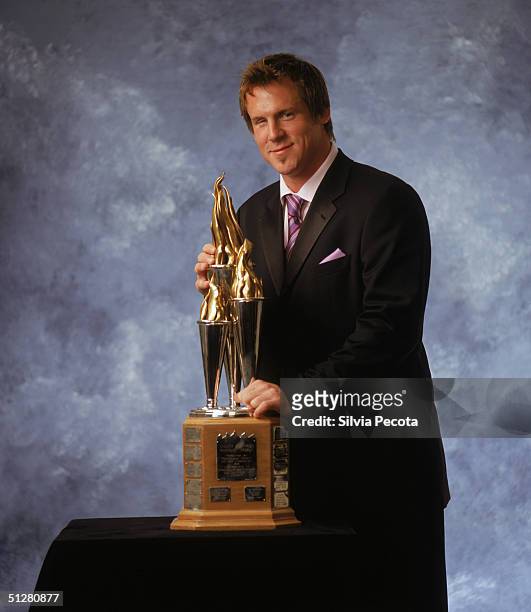 Bryan Berard of the Chicago Blackhawks poses with his Bill Masterton Trophy, awarded annually to the player who best exemplifies the qualities of...