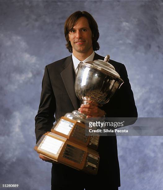 Scott Niedermayer of the New Jersey Devils poses with his James Norris Memorial Trophy, awarded annually to the National Hockey League's top...