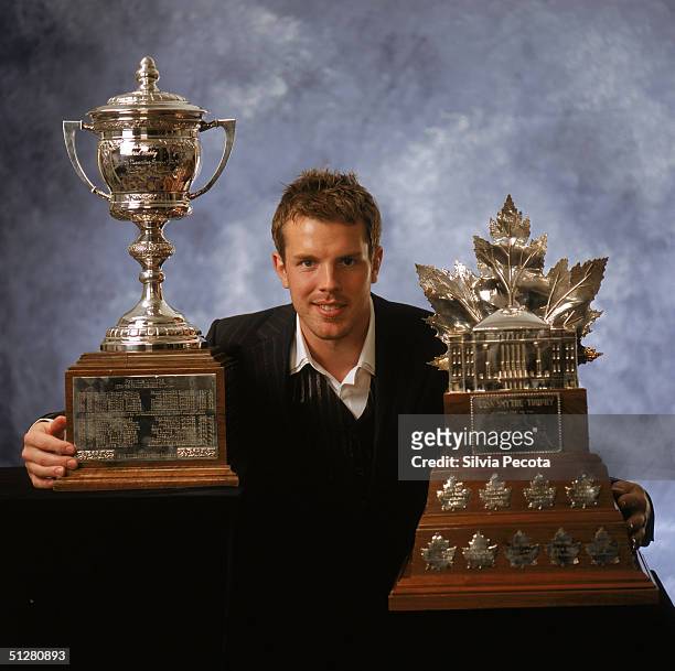 Brad Richards of the Tampa Bay Lightning poses with the Lady Byng Memorial Trophy and the Conn Smythe Trophy during the 2004 NHL Awards at the...