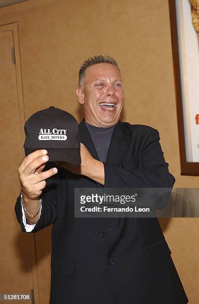 Tom Evangelista shows off his business cap as he attends the premiere of the HBO show Family Bonds on September 9, 2004 in New York City.