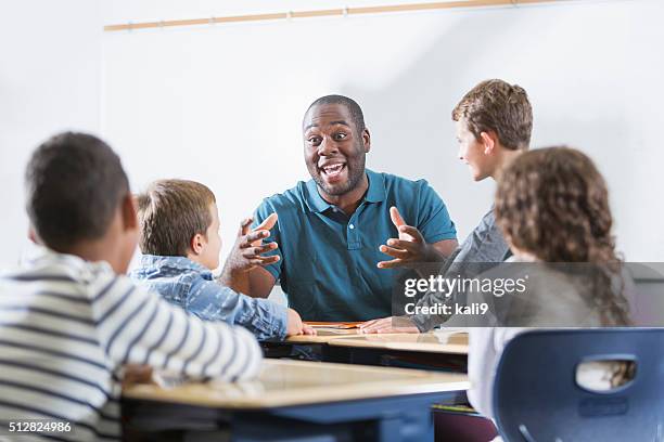 african american teacher and children in classroom - 5-10 2016 stock pictures, royalty-free photos & images