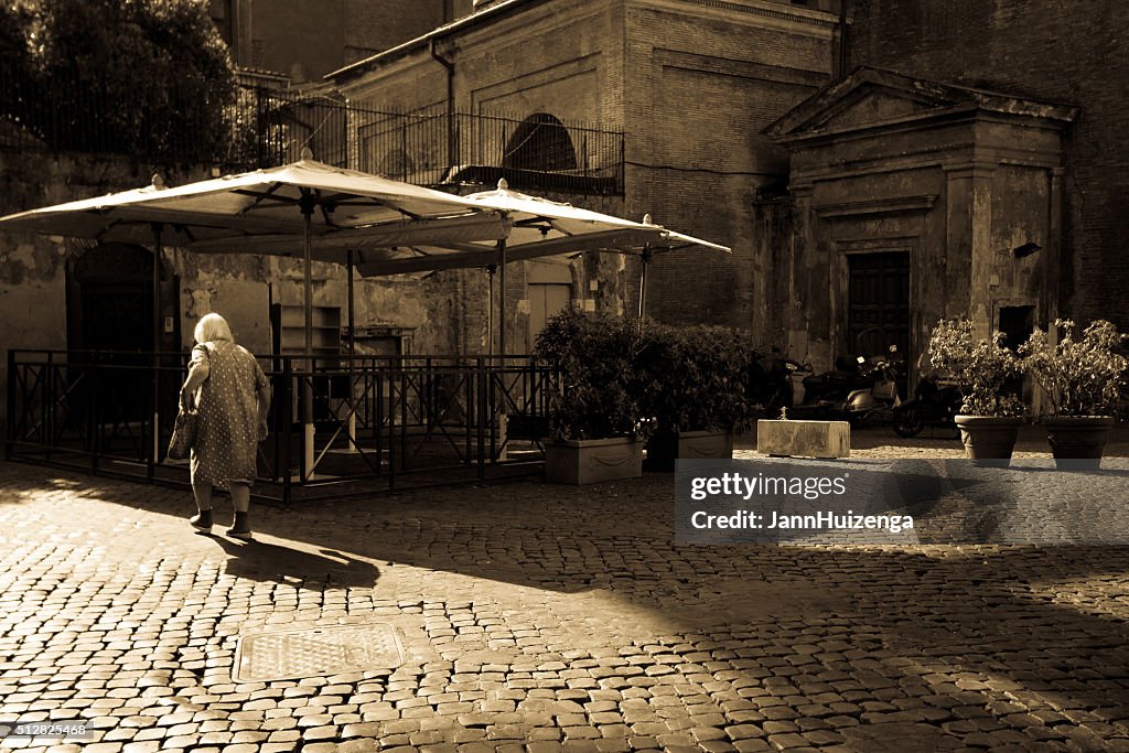 Rome, Italy: Senior Woman on Beautiful Empty Cobbled Piazza (Sepia)