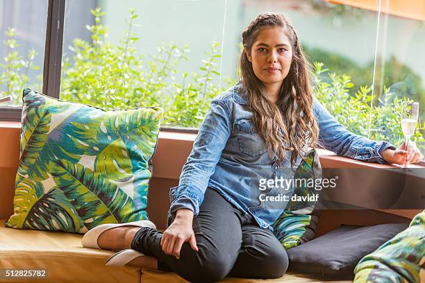young woman relaxing with a glass of champagne - aboriginal women stock pictures, royalty-free photos & images