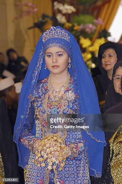 Commoner Sarah Salleh, dressed in radiant blue, is seen during her wedding to Bruneian Crown Prince Al-Muhtadee Billah Bolkiah in this official...