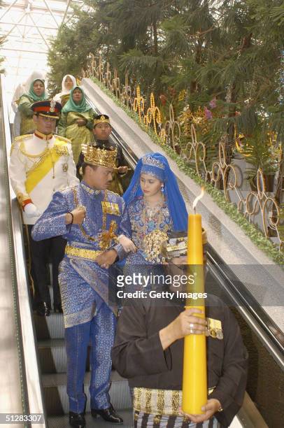 Bruneian Crown Prince Al-Muhtadee Billah Bolkiah and his bride, commoner Sarah Salleh, are seen during their wedding in this official handout photo...