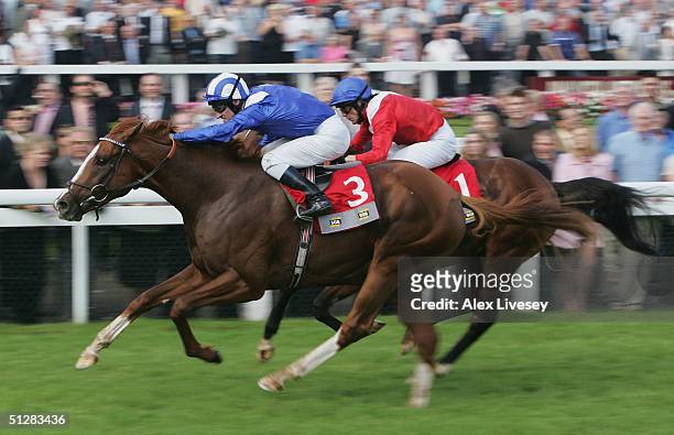 Etlaala ridden by Richard Hills beats Iceman ridden by Kieron Fallon to win the SGB Champagne Stakes at Doncaster Racecourse on September 10, 2004 in...