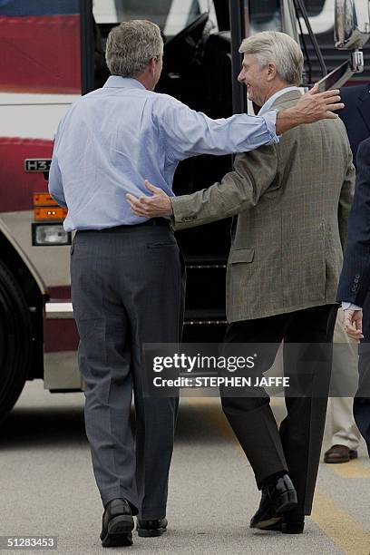 President George W. Bush and Democratic Senator Zell Miller get on the campaign bus 10 September, 2004 in Huntington, West Virginia for a day-trip of...