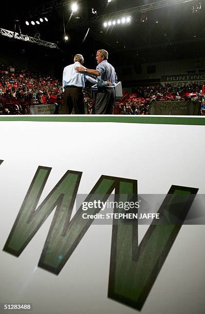 President George W. Bush embraces Democratic Senator Zell Miller at the Big Sandy Superstore Arena 10 September, 2004 in Huntington, West Virginia ....