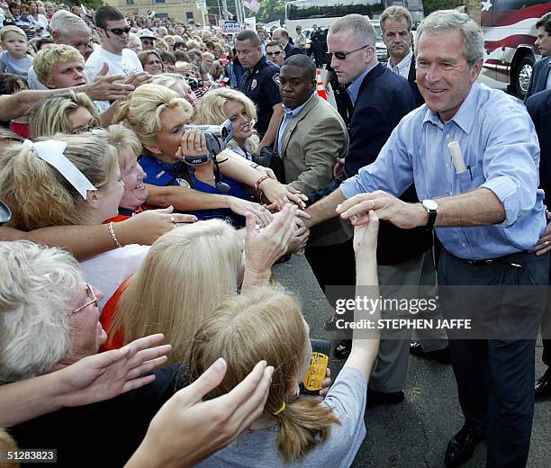 President George W. Bush shakes hands with supporters during an impromptu stop 10 September 2004 in Ironton, Ohio. Bush and Senator Miller are taking...