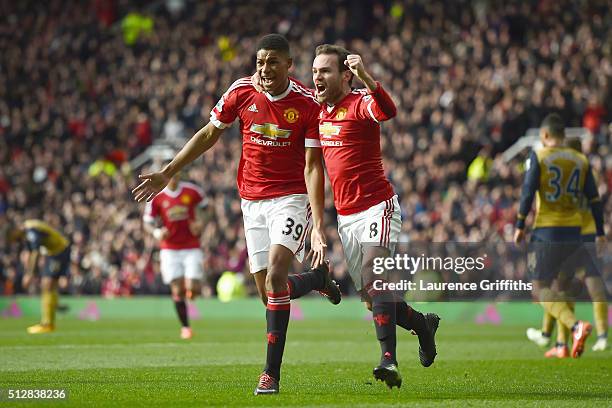 Marcus Rashford of Manchester United celebrates scoring his opening goal with Juan Mata during the Barclays Premier League match between Manchester...