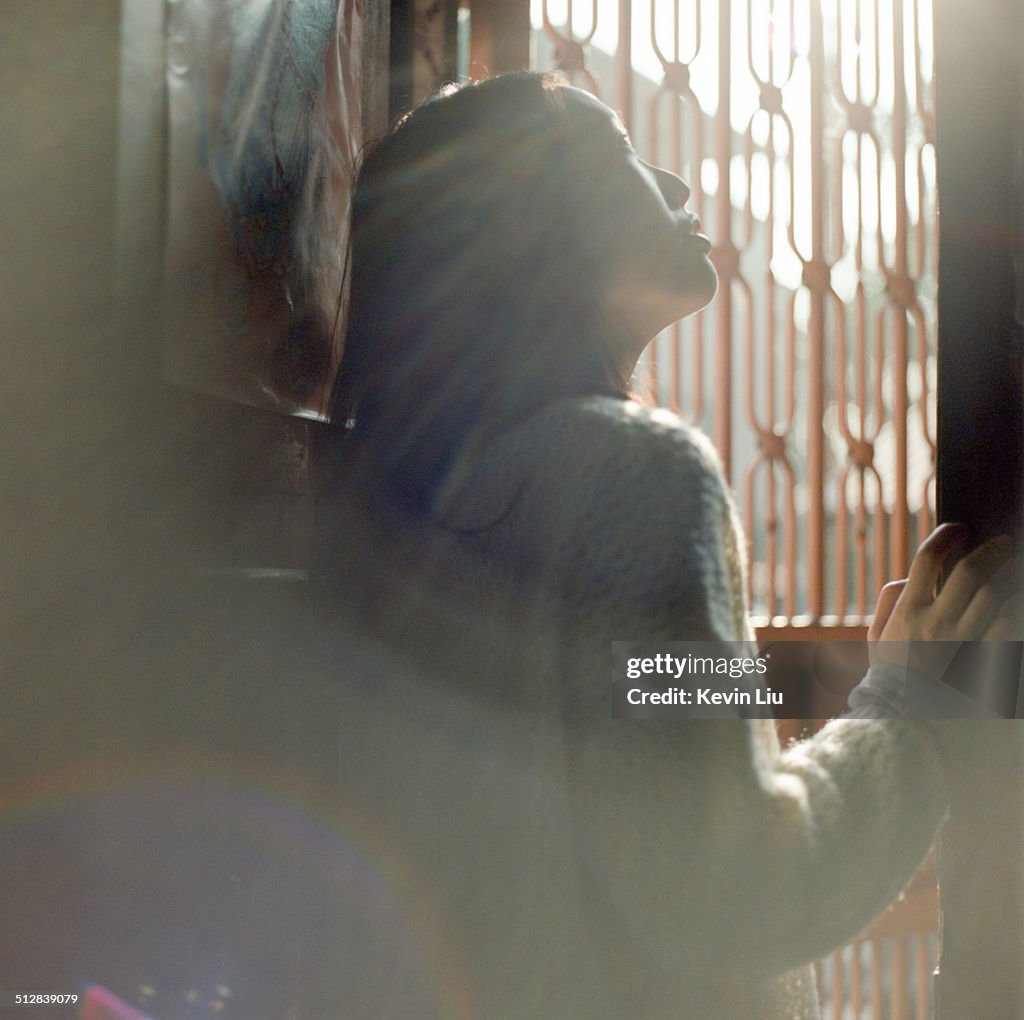 A lady looking out a doorway