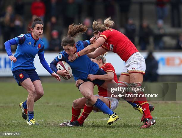Wales' flanker Rachel Taylor and Wales' fly half Elinor Snowsill tackle France's centre Lucille Godiveau during the Women's Six Nations international...