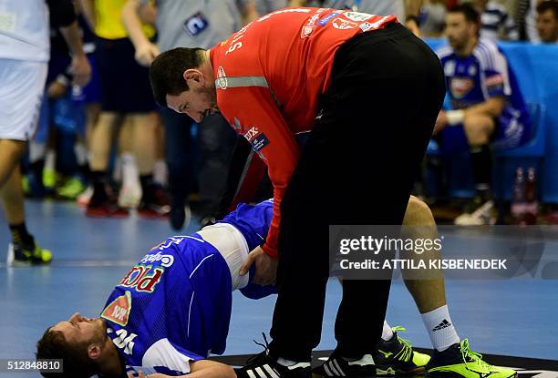 Hungarian Gabor Ancsin of Hungarian MOL-Pick Szeged is helped by his opponent, goalkeeper Arpad Sterbik of Macedonian HC Vardar in Szeged on February...